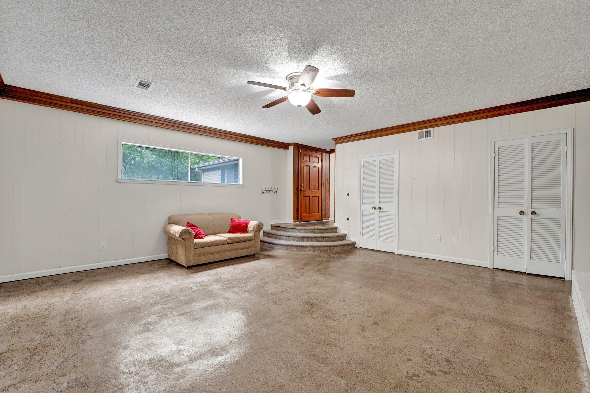 4328 Riche Road Memphis, TN 38128 - Photo 6 of 28 a view of an empty room with window and chandelier fan