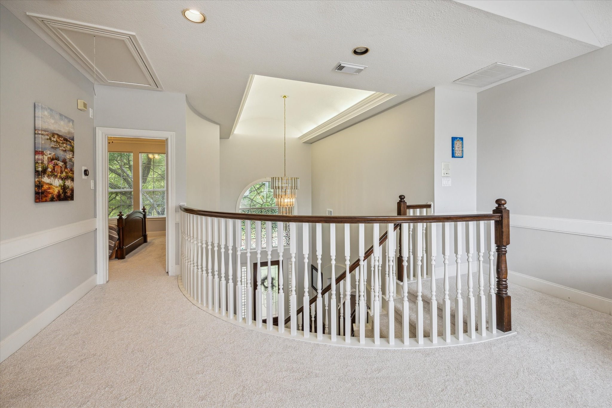 13627 Ashley Run Houston, TX 77077 - Photo 15 of 28 a view of staircase with lots of frames on wall and a large window
