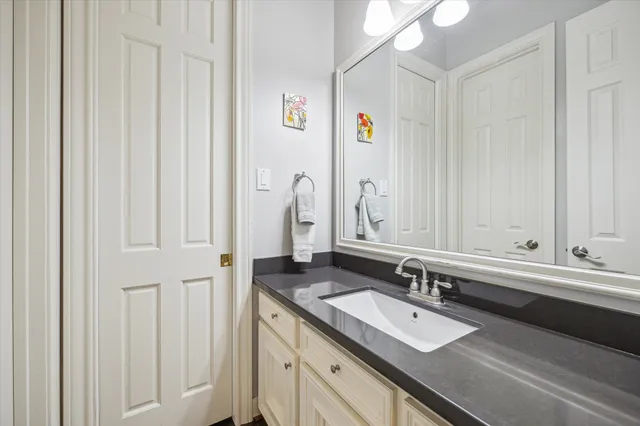 a bathroom with a double vanity sink and a mirror