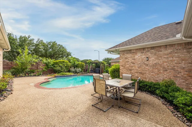 a view of backyard with outdoor seating and plants