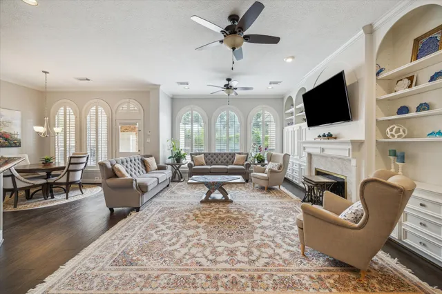 a living room with fireplace furniture and a flat screen tv