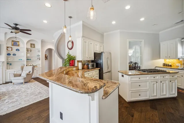 a kitchen with stainless steel appliances granite countertop a sink and a refrigerator