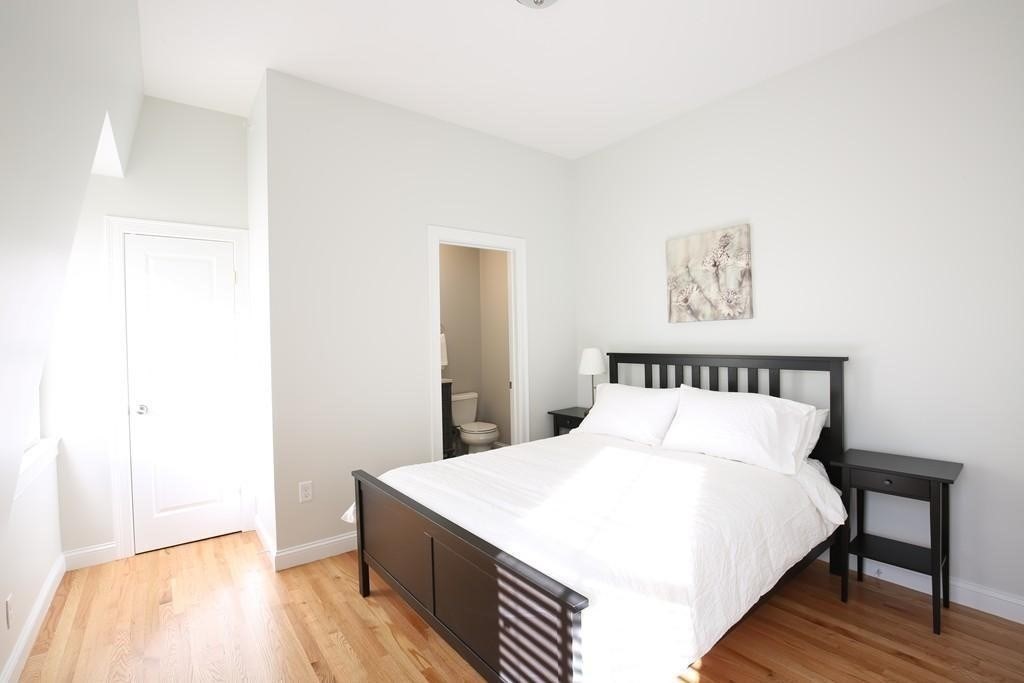 20 George Street, Unit 2L Somerville, MA 02145 - Photo 5 of 8 a large bed in a white room