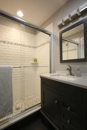 a bathroom with a sink vanity granite and a mirror