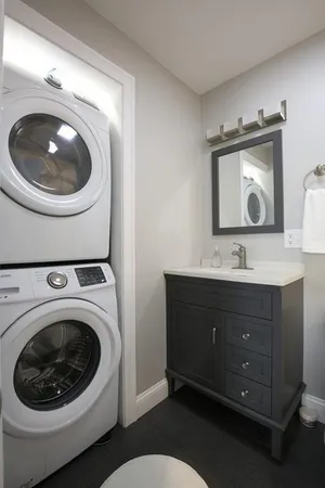 a bathroom with a toilet sink and mirror