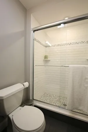 a bathroom with a toilet and a shower