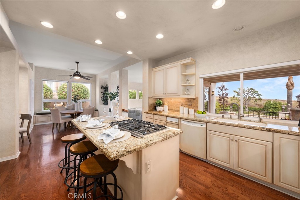 5501 Carriage Place Rancho Cucamonga, CA 91737 - Photo 12 of 60 a kitchen with a table chairs stove and cabinets