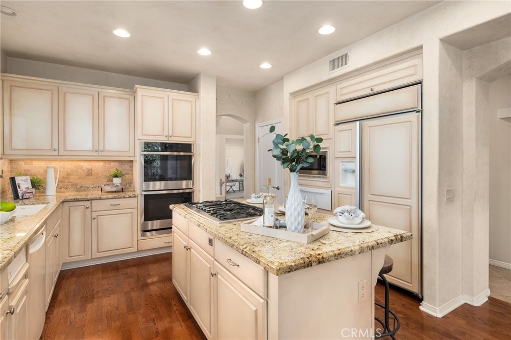 5501 Carriage Place Rancho Cucamonga, CA 91737 - Photo 13 of 60 a kitchen with a sink stove and refrigerator
