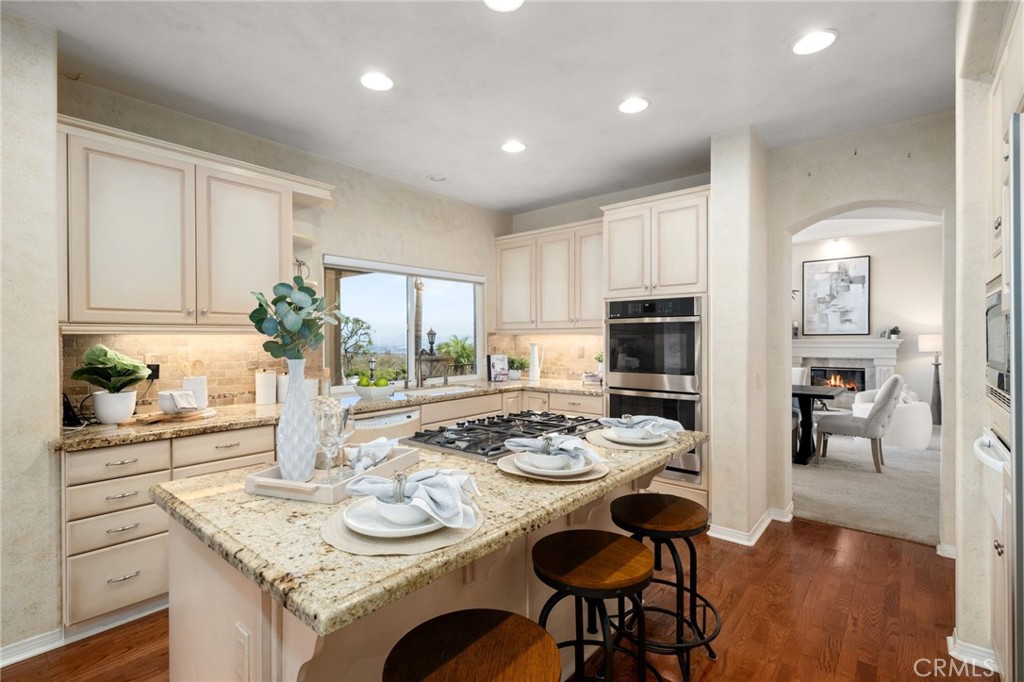 5501 Carriage Place Rancho Cucamonga, CA 91737 - Photo 14 of 60 a dining room with furniture and wooden floor