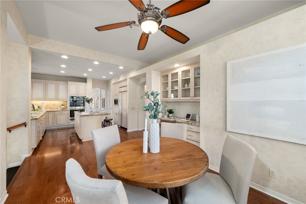 5501 Carriage Place Rancho Cucamonga, CA 91737 - Photo 18 of 60 a dining room with furniture and a kitchen view