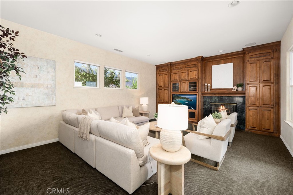 5501 Carriage Place Rancho Cucamonga, CA 91737 - Photo 20 of 60 a living room with furniture fireplace and a large window