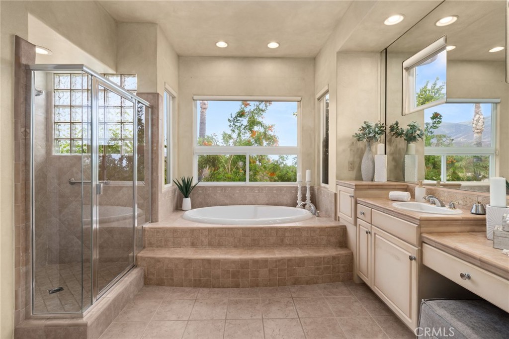 5501 Carriage Place Rancho Cucamonga, CA 91737 - Photo 28 of 60 a spacious bathroom with a large tub shower and sink