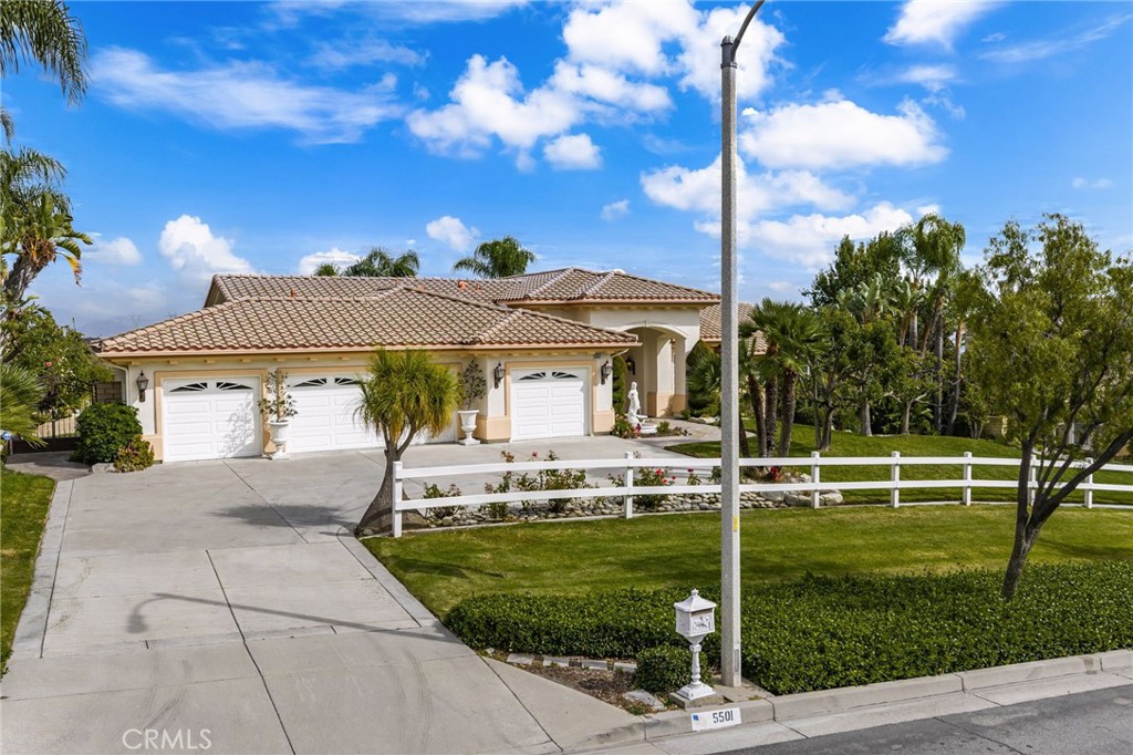5501 Carriage Place Rancho Cucamonga, CA 91737 - Photo 3 of 60 a front view of a house with a garden