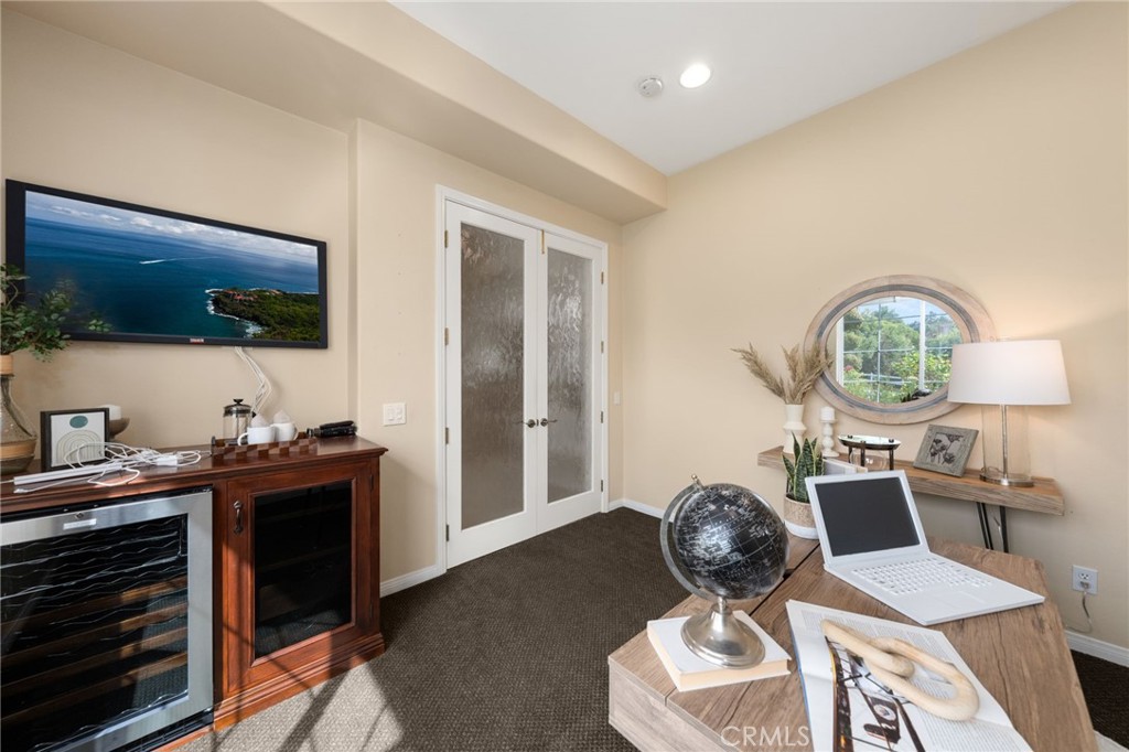 5501 Carriage Place Rancho Cucamonga, CA 91737 - Photo 35 of 60 a living room with furniture a flat screen tv and a floor to ceiling window