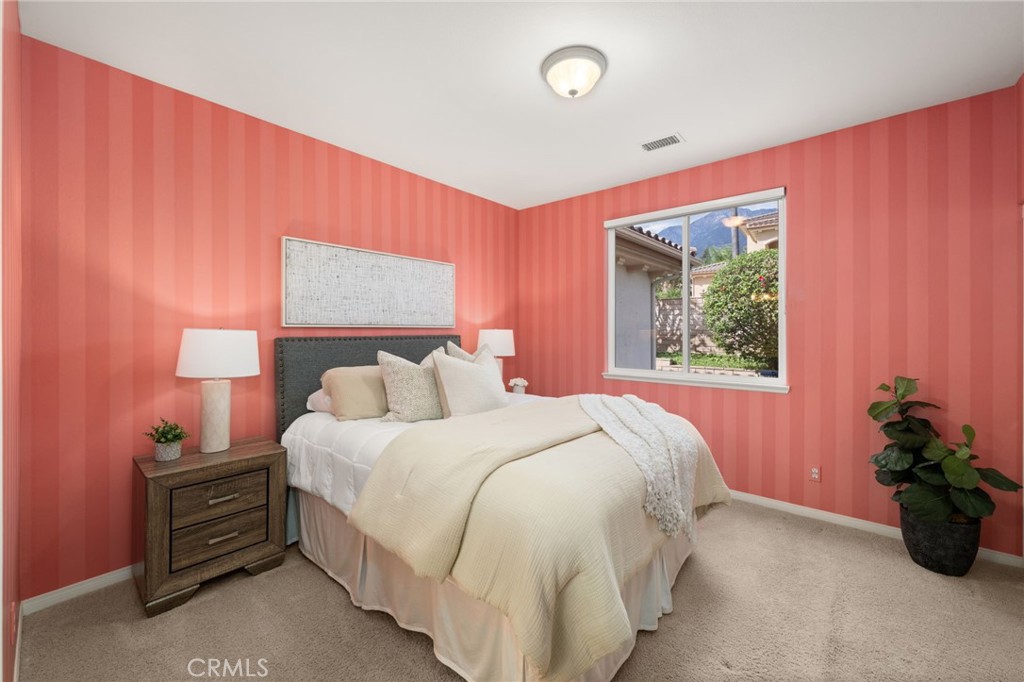 5501 Carriage Place Rancho Cucamonga, CA 91737 - Photo 37 of 60 a bedroom with a bed and a potted plant
