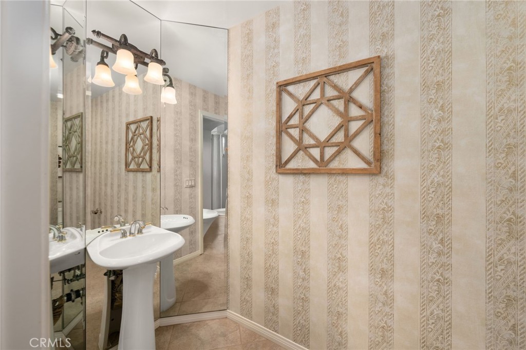 5501 Carriage Place Rancho Cucamonga, CA 91737 - Photo 40 of 60 a bathroom with a sink and a mirror