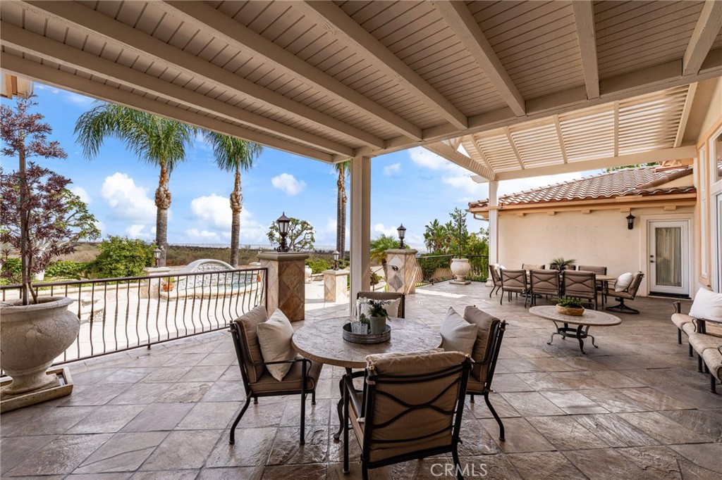 5501 Carriage Place Rancho Cucamonga, CA 91737 - Photo 42 of 60 a view of a patio with a dining table and chairs with wooden floor