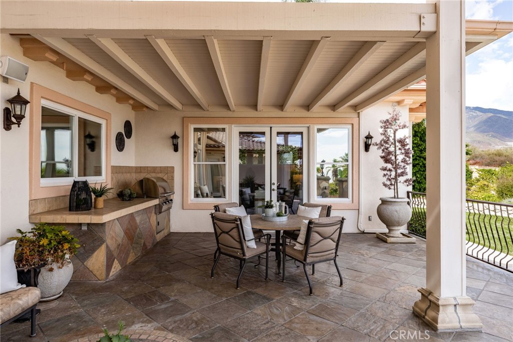 5501 Carriage Place Rancho Cucamonga, CA 91737 - Photo 43 of 60 a dining room with furniture floor to ceiling window and potted plants
