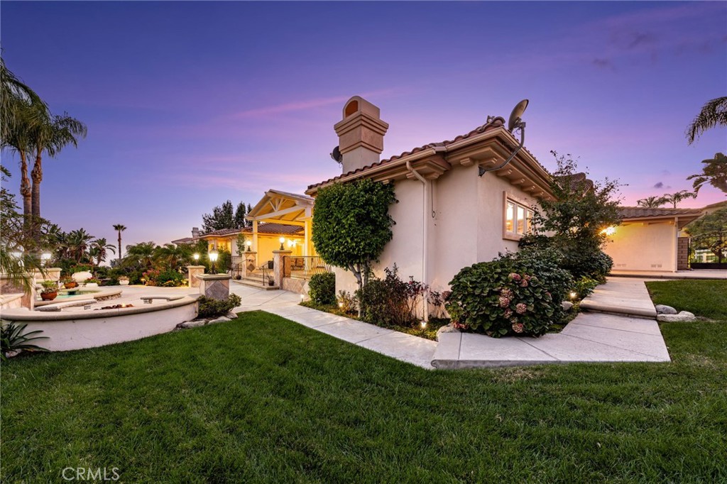 5501 Carriage Place Rancho Cucamonga, CA 91737 - Photo 50 of 60 a front view of a house with garden