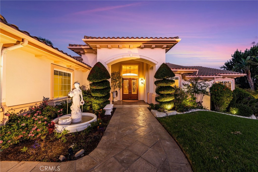 5501 Carriage Place Rancho Cucamonga, CA 91737 - Photo 5 of 60 a front view of a house with garden