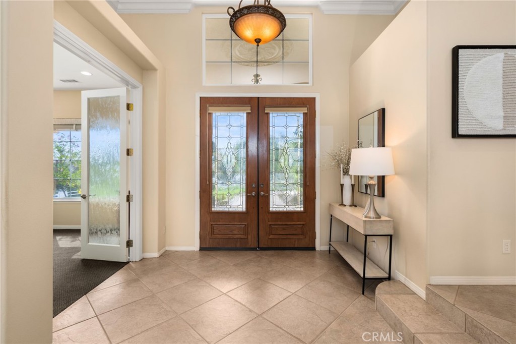 5501 Carriage Place Rancho Cucamonga, CA 91737 - Photo 6 of 60 a spacious bedroom with a bed and a chandelier