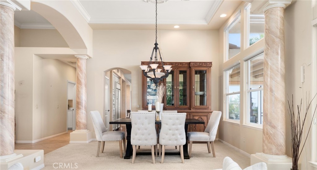 5501 Carriage Place Rancho Cucamonga, CA 91737 - Photo 10 of 60 a dining room with furniture a chandelier and window
