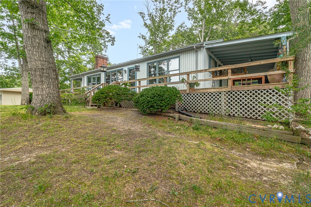 142 Bridge Lane Reedville, VA 22539 - Photo 44 of 56 a white house that has a small yard and large trees