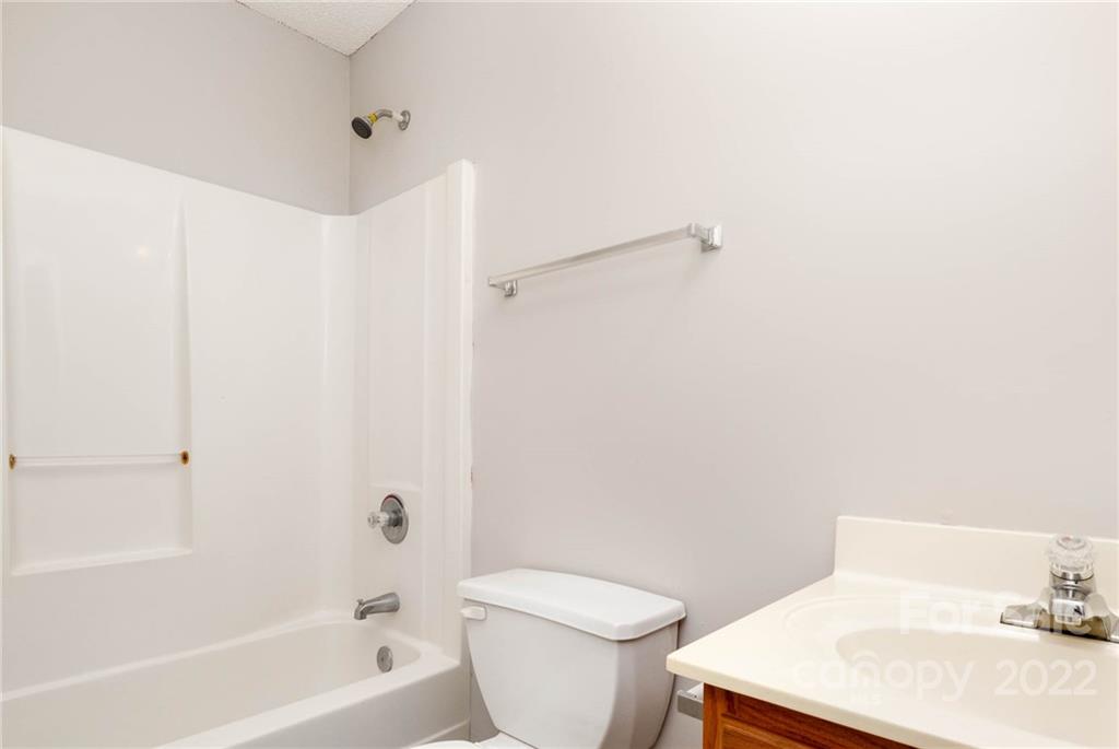 2800 Oneida Road Charlotte, NC 28269 - Photo 15 of 18 a white toilet sitting next to a bath tub