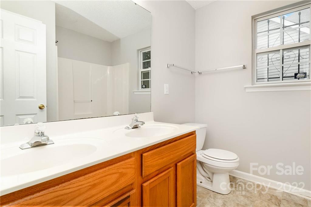 2800 Oneida Road Charlotte, NC 28269 - Photo 16 of 18 a bathroom with a sink a toilet and a window