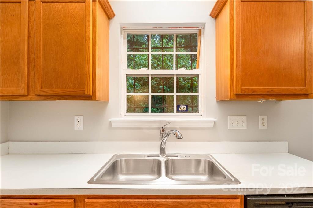 2800 Oneida Road Charlotte, NC 28269 - Photo 5 of 18 a kitchen sink with a granite countertop window