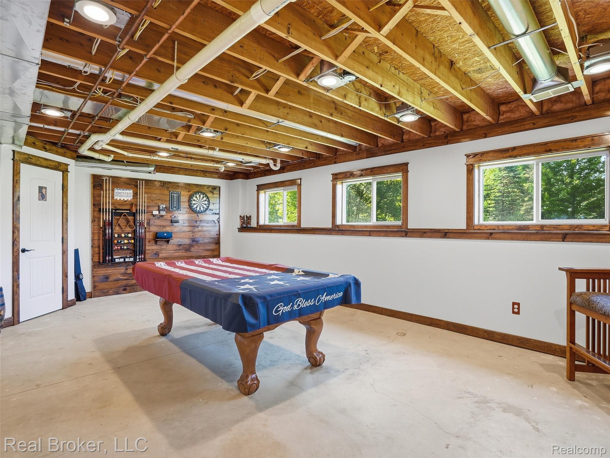7271 West Ray Road Gaines, MI 48436 - Photo 40 of 48 Spacious lower level featuring exposed wood beam ceiling, recessed lighting, concrete flooring, and two windows providing natural light