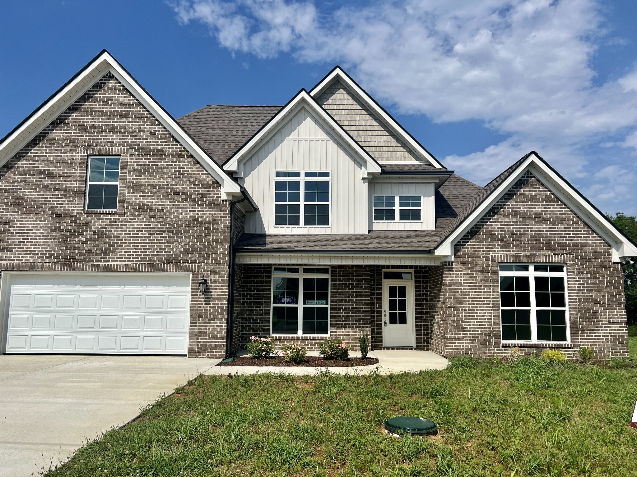 a front view of a house with a yard and porch