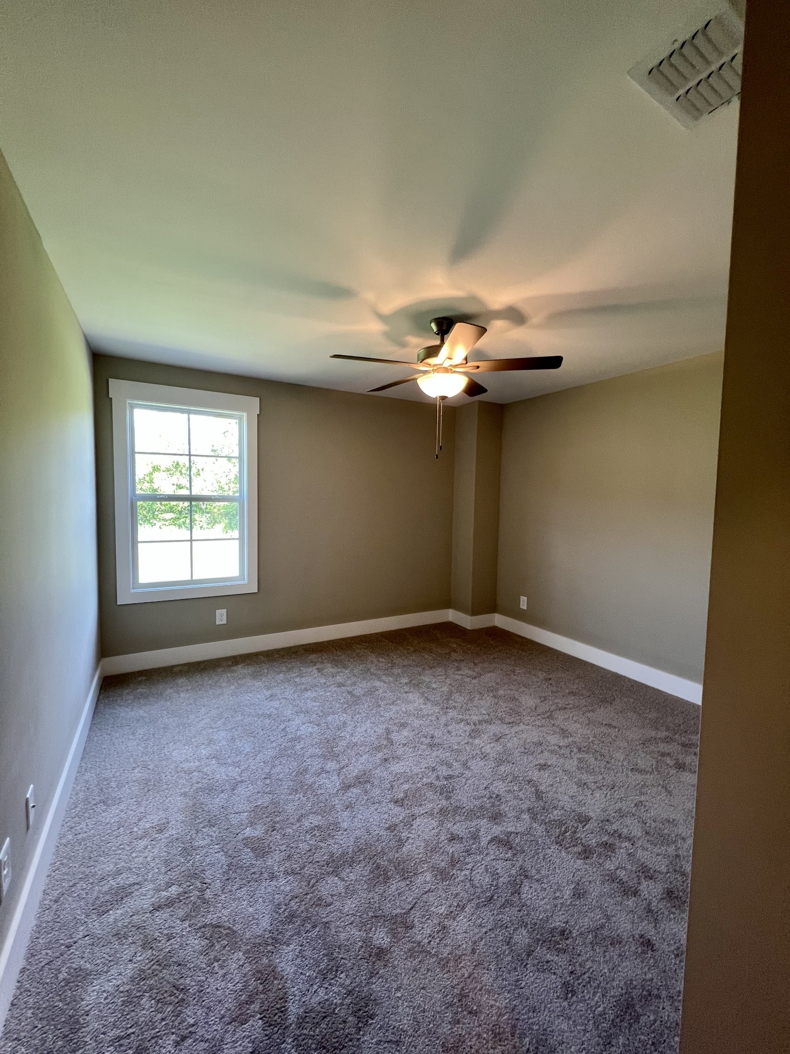 1442 Millstone Creek Road Lascassas, TN 37085 - Photo 25 of 30 an empty room with windows and chandelier fan