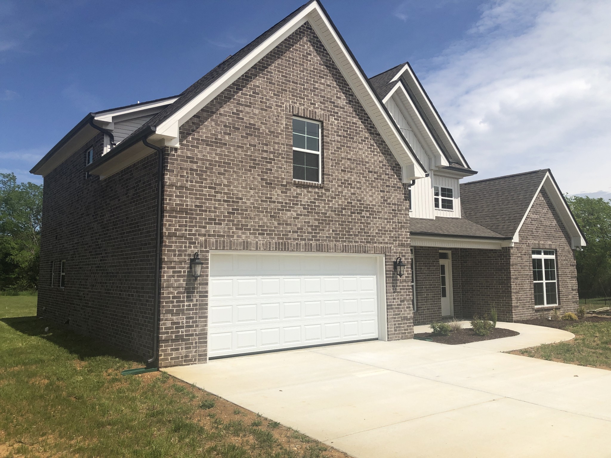 1442 Millstone Creek Road Lascassas, TN 37085 - Photo 4 of 30 a front view of a house with a yard and garage