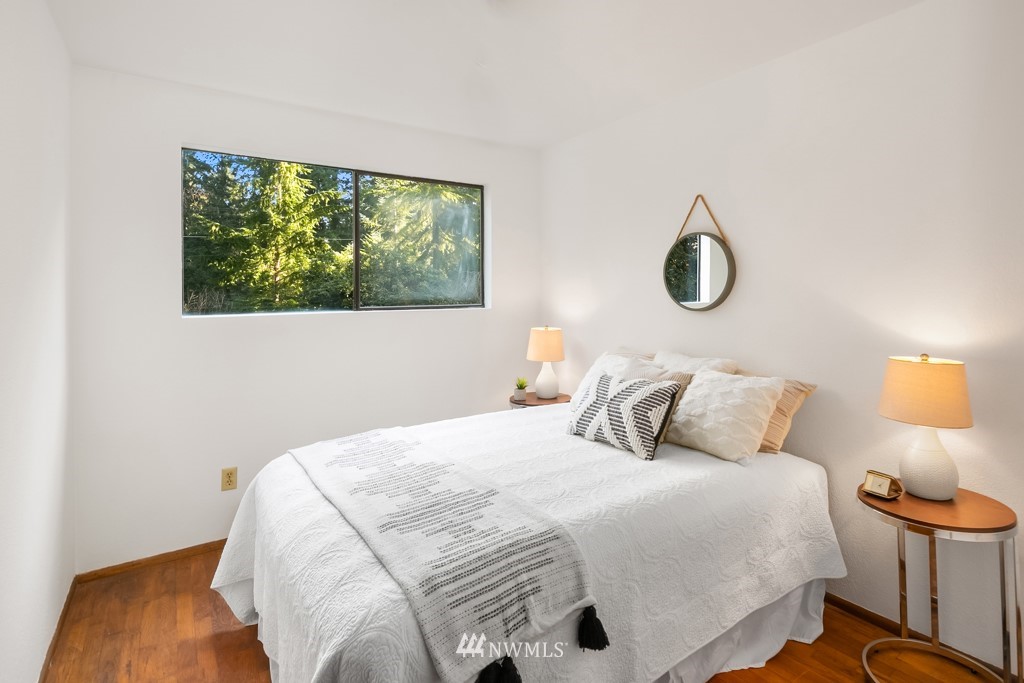 17721 Beall Road Southwest Vashon, WA 98070 - Photo 15 of 35 a bedroom with a bed and a window