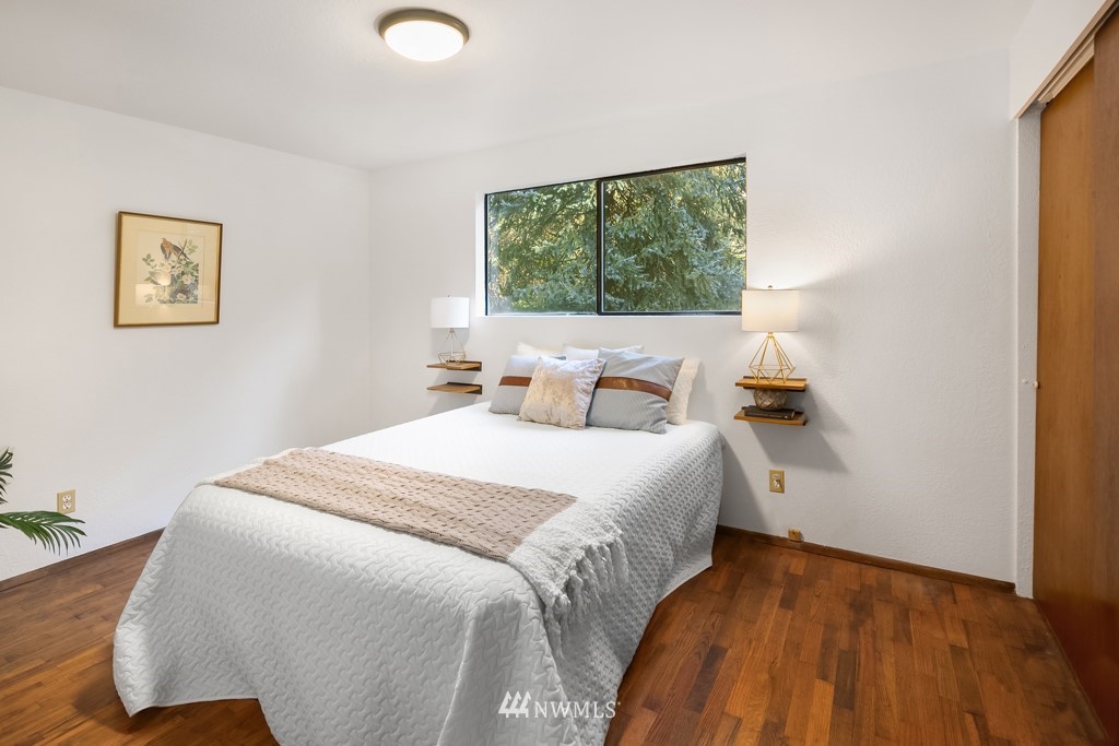 17721 Beall Road Southwest Vashon, WA 98070 - Photo 16 of 35 a bedroom with a bed and window