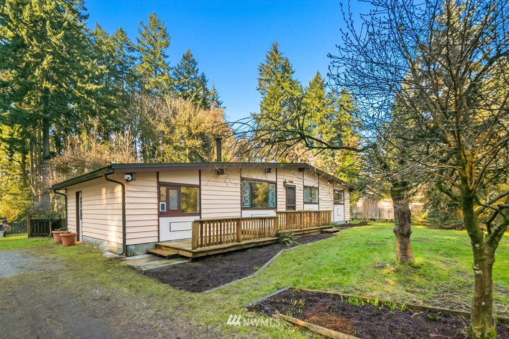 17721 Beall Road Southwest Vashon, WA 98070 - Photo 2 of 35 a small white house with a white fence