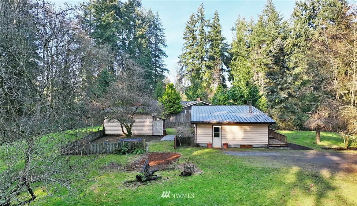17721 Beall Road Southwest Vashon, WA 98070 - Photo 24 of 35 a front view of a house with garden