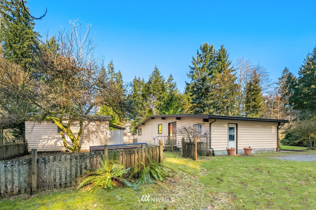 17721 Beall Road Southwest Vashon, WA 98070 - Photo 26 of 35 a front view of house with yard and trees