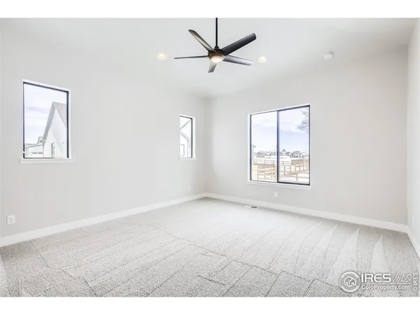 a view of a livingroom with a hardwood floor and a ceiling fan