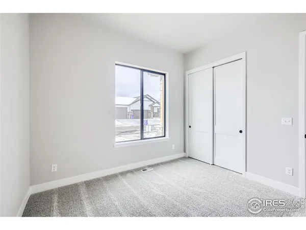 a view of a kitchen with kitchen island a sink wooden floor and stainless steel appliances