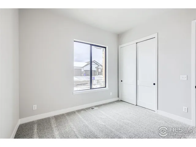 a view of a kitchen with kitchen island a sink wooden floor and stainless steel appliances