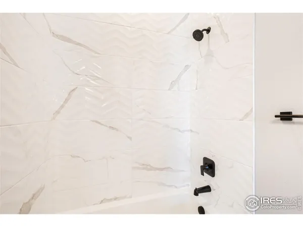 a bathroom with a sink a toilet a shower and a mirror