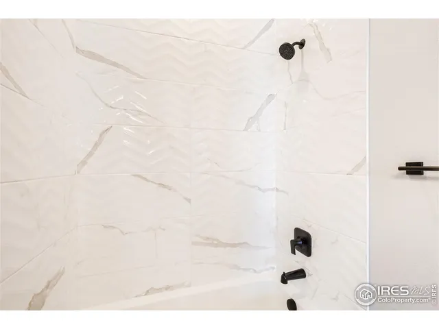 a bathroom with a sink a toilet a shower and a mirror