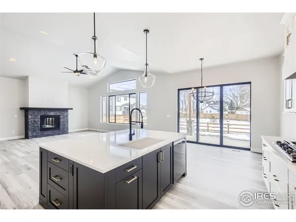 a kitchen with refrigerator cabinets and a sink