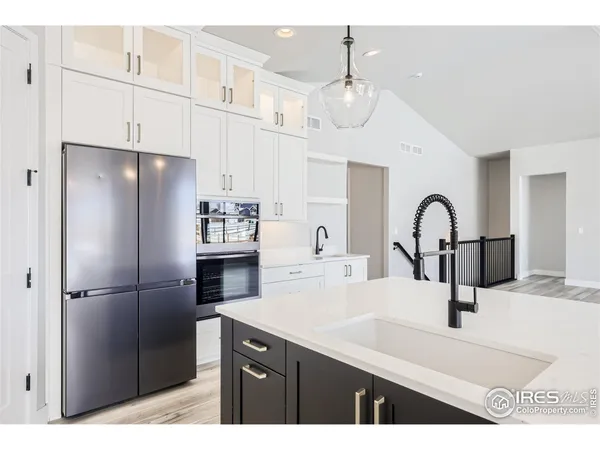a kitchen with kitchen island a counter top space wooden floor and appliances