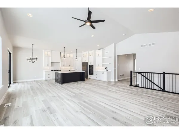 a view of an empty room with a window and fireplace