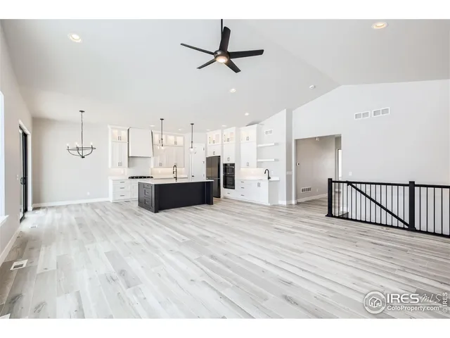 a view of an empty room with a window and fireplace