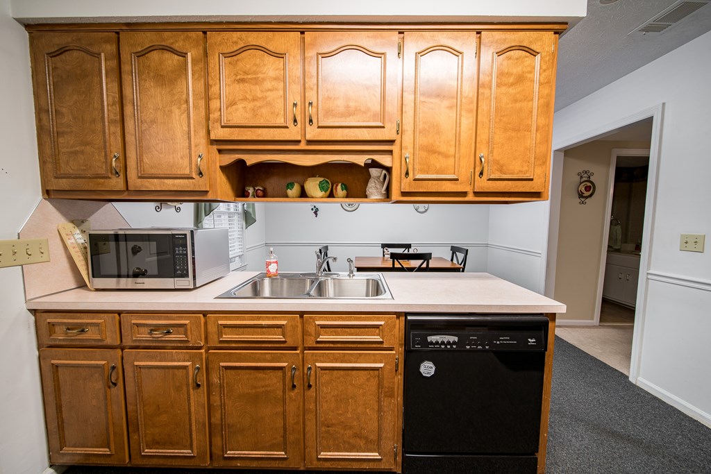 6101 River Road, Unit 42 Columbus, GA 31904 - Photo 12 of 28 a kitchen with stainless steel appliances granite countertop a sink and a cabinets