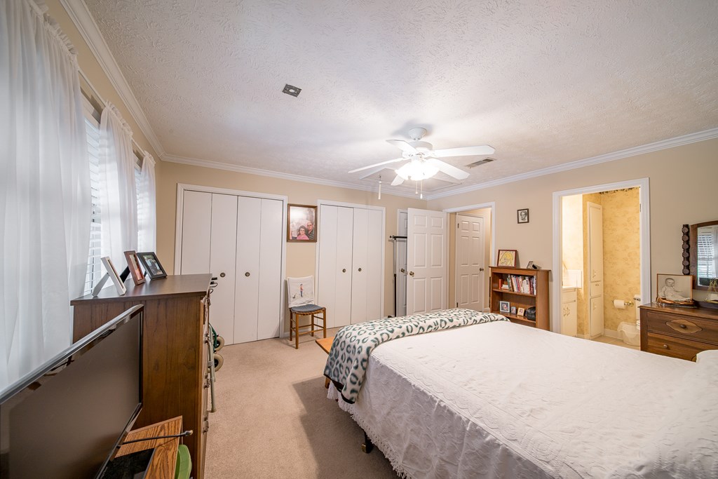 6101 River Road, Unit 42 Columbus, GA 31904 - Photo 17 of 28 a spacious bedroom with a bed and a chandelier